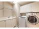 Laundry room with washer, dryer, cabinets and sink at 424 Luna Bella Ln # 433, New Smyrna Beach, FL 32168
