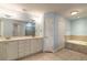 Double vanity bathroom with a soaking tub and separate shower at 424 Luna Bella Ln # 433, New Smyrna Beach, FL 32168