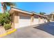Three-car garage with white doors and light beige exterior at 424 Luna Bella Ln # 433, New Smyrna Beach, FL 32168