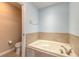 Bathroom with a jetted tub and separate toilet area at 424 Luna Bella Ln # 433, New Smyrna Beach, FL 32168