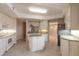 Island kitchen with granite countertops and white cabinets at 424 Luna Bella Ln # 433, New Smyrna Beach, FL 32168