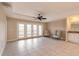Living room with tile floors, access to balcony and ceiling fan at 424 Luna Bella Ln # 433, New Smyrna Beach, FL 32168