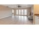 Open living area with tile floors and access to balcony at 424 Luna Bella Ln # 433, New Smyrna Beach, FL 32168