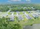 Aerial view of a residential neighborhood with houses and a pond at 350 Sunset Point Dr, Ormond Beach, FL 32174