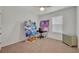 Bedroom with window, carpet, and art supplies at 350 Sunset Point Dr, Ormond Beach, FL 32174
