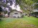 Landscaped backyard with lush lawn and mature trees at 1780 Otisco Way, Winter Springs, FL 32708