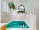 Bathroom with teal jacuzzi tub and glass block accents at 1780 Otisco Way, Winter Springs, FL 32708