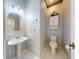 Small half bathroom with pedestal sink and striped wallpaper at 1780 Otisco Way, Winter Springs, FL 32708