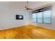 Hardwood floor bedroom with large window and TV mount at 1780 Otisco Way, Winter Springs, FL 32708