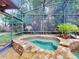 Relax in this screened-in hot tub, nestled amongst lush landscaping at 1780 Otisco Way, Winter Springs, FL 32708
