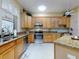 Spacious kitchen with wood cabinets, granite counters and stainless steel appliances at 1780 Otisco Way, Winter Springs, FL 32708