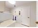 Laundry room with a sink, storage, and access to other areas at 1780 Otisco Way, Winter Springs, FL 32708