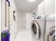 Bright laundry room with washer, dryer, and utility sink at 1780 Otisco Way, Winter Springs, FL 32708