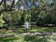 Serene pond with fountain and bench in a lush setting at 1780 Otisco Way, Winter Springs, FL 32708