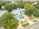 House with a large yard, driveway, and surrounding trees at 412 S Peninsula Ave, New Smyrna Beach, FL 32169