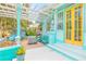 Inviting front porch with pergola, hanging chairs, and fire pit at 412 S Peninsula Ave, New Smyrna Beach, FL 32169