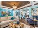Open living space with hardwood floors, large windows and coastal-themed art at 412 S Peninsula Ave, New Smyrna Beach, FL 32169