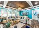 Bright living room with vaulted ceilings, comfy sectional sofa, and coastal decor at 412 S Peninsula Ave, New Smyrna Beach, FL 32169