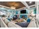 Living room with sectional sofa, fireplace, and wood beams at 412 S Peninsula Ave, New Smyrna Beach, FL 32169