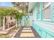 Charming side yard with unique gate and stone pathway at 412 S Peninsula Ave, New Smyrna Beach, FL 32169