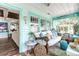 Bright sunroom with comfy daybed and coastal decor at 412 S Peninsula Ave, New Smyrna Beach, FL 32169