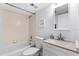 Bathroom with tub, toilet and white vanity at 4139 S Atlantic Ave # B103, New Smyrna Beach, FL 32169