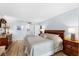 Spacious bedroom with king-size bed and wood furniture at 4139 S Atlantic Ave # B103, New Smyrna Beach, FL 32169