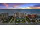 Oceanfront building at sunset, with tennis courts at 4139 S Atlantic Ave # B103, New Smyrna Beach, FL 32169