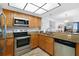 Modern kitchen featuring stainless steel appliances and wood cabinets at 4139 S Atlantic Ave # B103, New Smyrna Beach, FL 32169