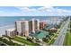 Aerial view of beachfront building and tennis court at 4139 S Atlantic Ave # B103, New Smyrna Beach, FL 32169
