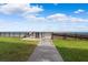 Beach access pathway with boardwalk and gate, leading to sandy beach at 4139 S Atlantic Ave # B103, New Smyrna Beach, FL 32169