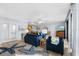 Open living space with blue sofas, ocean view, and hardwood floors at 4139 S Atlantic Ave # B103, New Smyrna Beach, FL 32169