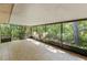 Screened porch with tiled floor and wooded views at 4660 Holly Rd, New Smyrna Beach, FL 32168