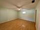 Large bedroom with light walls, hardwood floors and a ceiling fan at 101 Braeburn Cir, Daytona Beach, FL 32114