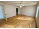 Large bedroom with hardwood floors, a window, and an attached bathroom at 101 Braeburn Cir, Daytona Beach, FL 32114
