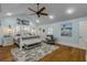 Main bedroom with a king-size bed, vaulted ceilings, and a ceiling fan at 412 S Peninsula Ave, New Smyrna Beach, FL 32169