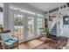 Relaxing sunroom with French doors leading to the backyard at 412 S Peninsula Ave, New Smyrna Beach, FL 32169