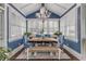 Bright dining area featuring a wooden table, blue chairs, and built-in bench at 412 S Peninsula Ave, New Smyrna Beach, FL 32169