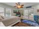 Bedroom with a comfortable bed, ceiling fan, and access to the backyard at 412 S Peninsula Ave, New Smyrna Beach, FL 32169