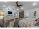 Main bedroom with a king-size bed, hardwood floors, and a large TV at 412 S Peninsula Ave, New Smyrna Beach, FL 32169