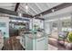 Open kitchen with island, stainless steel appliances, and access to backyard at 412 S Peninsula Ave, New Smyrna Beach, FL 32169