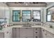 L-shaped kitchen with granite countertops and a stylish sink at 412 S Peninsula Ave, New Smyrna Beach, FL 32169