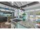 Island kitchen with gas range, granite counters, and access to the backyard at 412 S Peninsula Ave, New Smyrna Beach, FL 32169