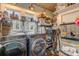 Laundry room with washer, dryer, and ample storage shelving at 412 S Peninsula Ave, New Smyrna Beach, FL 32169