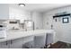Bright and airy kitchen with white cabinets and breakfast bar at 3509 S Atlantic Ave # 209, New Smyrna Beach, FL 32169