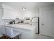 Clean and efficient kitchen featuring white cabinetry and appliances at 3509 S Atlantic Ave # 209, New Smyrna Beach, FL 32169