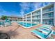 Refreshing pool with plenty of lounge chairs and patio tables at 3509 S Atlantic Ave # 209, New Smyrna Beach, FL 32169