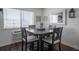 Small dining area with four chairs and a dark wood table at 3509 S Atlantic Ave # 209, New Smyrna Beach, FL 32169