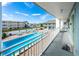 View from a balcony overlooking the refreshing pool and courtyard at 3509 S Atlantic Ave # 209, New Smyrna Beach, FL 32169