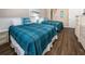 Guest bedroom with two twin beds and light wood floors at 3509 S Atlantic Ave # 209, New Smyrna Beach, FL 32169